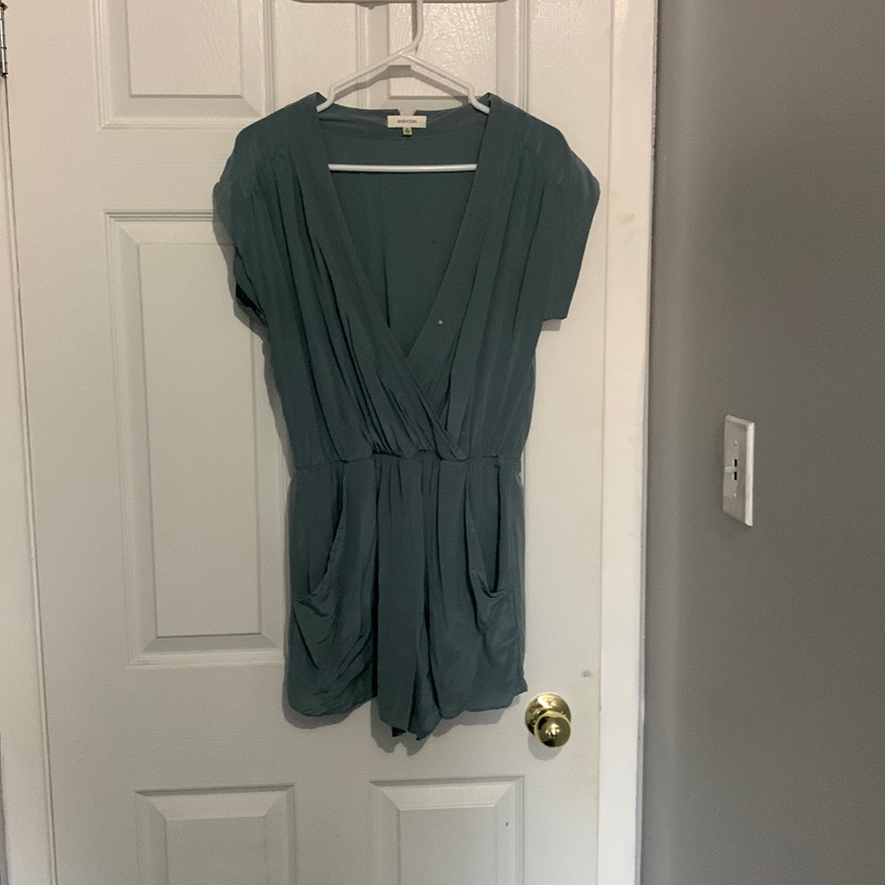 Green aritzia romper with slight rip